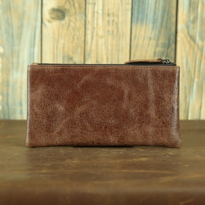 Macro shot of vintage brown leather wallet texture with top metal zipper closure