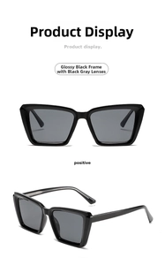 Macro view of oversized square sunglasses with shiny black frames and grey lenses