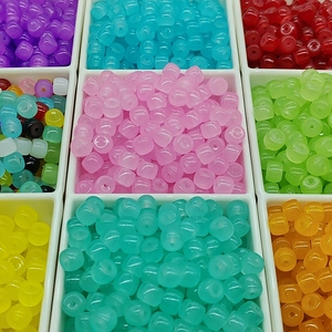 Colorful 6x8mm barrel beads organized in a transparent grid storage box for DIY jewelry