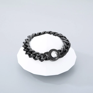 Detailed view of black polished Cuban link chain bracelet with a clear crystal charm