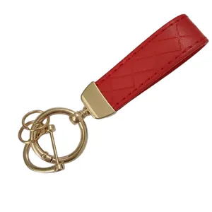 Red braided leather keychain with gold zinc alloy hardware on a plain white background