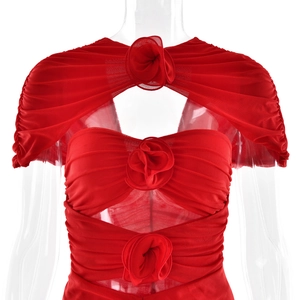 Detail of red sleeveless cutout dress featuring pleated tulle and 3D floral accents