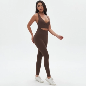 Detail of seamless dark brown yoga set featuring high waist leggings and cross-back sports bra