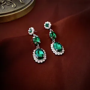 Elegant emerald-style drop earrings with silver base and sparkling white diamonds
