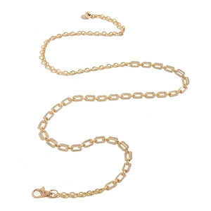 Detail of gold rhinestone metal chain belt with lobster clasp on white background