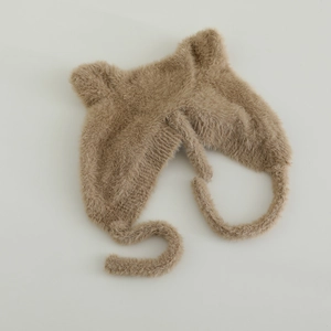 Detail of plush baby winter hat with cute ears and soft faux fur warm earflaps in brown