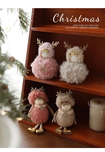 Close-up of plush angel dolls with golden antlers and sequins for Christmas tree decor