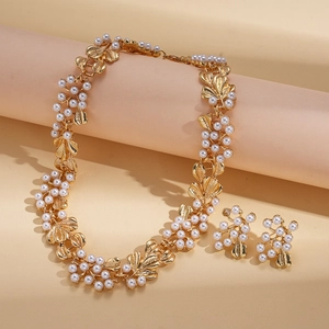 Vintage gold leaf and pearl jewelry set featuring an elegant floral necklace and earrings
