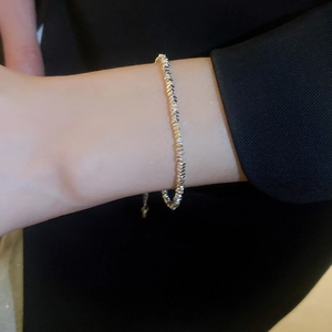 Close-up of a minimalist silver beaded bracelet with geometric cuts on a female wrist