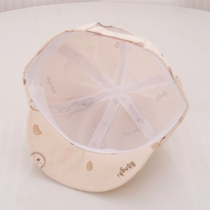Cute bear print baby baseball cap in cream cotton featuring a soft brim for toddlers