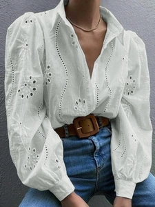 Detail of white puff sleeves and hollow floral embroidery on a V-neck cardigan