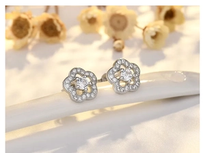 Macro shot of silver plum blossom earrings with sparkling micro-paved cubic zirconia