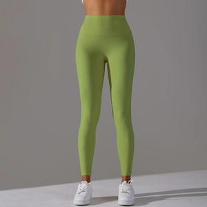 Detail view of high-waisted grass green yoga pants showing wide waistband and fabric texture