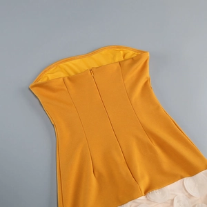 Close-up of yellow tube dress back with invisible zipper and white floral mesh trim
