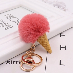 Close-up of a pink pom pom ice cream keychain with a realistic waffle cone and gold clasp