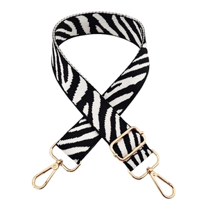 Adjustable wide shoulder strap featuring zebra pattern and polished gold metal hooks