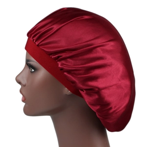 Burgundy silky satin bonnet sleep cap for hair protection shown on a model profile