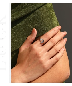Detail of S925 silver mermaid tail ring featuring blue gems and shimmering crystals