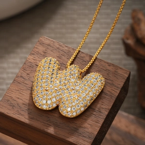 Detailed macro shot of 18K gold butterfly pendant with sparkling cubic zirconia inlay