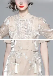 Detail of high collar with traditional knots and floral embroidery on gold fabric