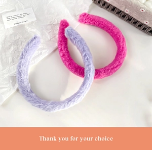 Detail of plush faux rabbit fur headbands in rose red and soft lilac candy colors