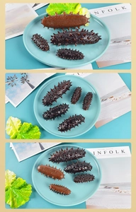 Detailed realistic sea cucumber models in multiple sizes with textured spikes on a blue plate