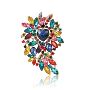 Exquisite gold alloy brooch with colorful glass crystals and a blue heart gemstone
