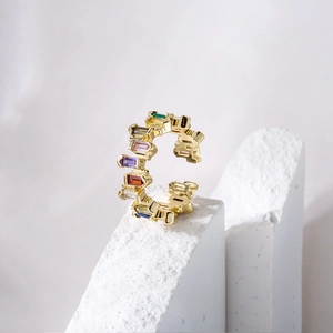 Macro detail of 18K gold plated ring with vibrant rainbow rectangle cut zircons