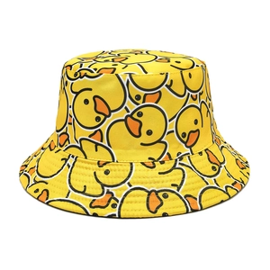 Detail of yellow cotton bucket hat featuring cute rubber duck pattern and reinforced stitched brim