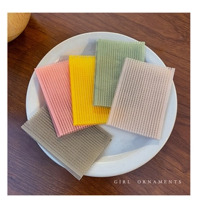 Macro shot of 5 colorful nylon hair pad stickers on a white plate for styling bangs