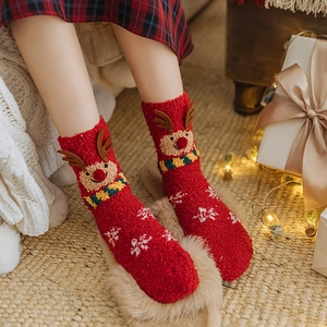 Plush Christmas reindeer socks in festive red coral fleece for winter warmth