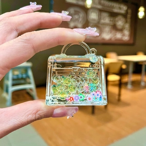Close-up of acrylic handbag keychain with colorful flowers and fluid bubble charms