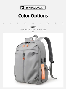 Detail of grey waterproof laptop backpack with orange accents and external USB charging port