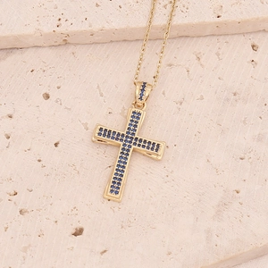 Dettaglio del ciondolo a croce placcato oro 18K con micro-pavé di pietre blu