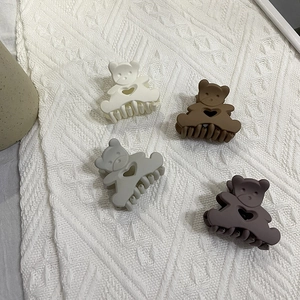 Matte macaron bear hair claw clips in cream, brown, grey, and purple colors