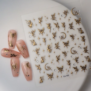 Macro view of gold foil fairy and moon nail art stickers on pastel manicure Co-192