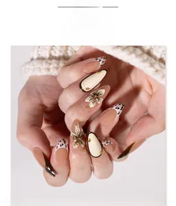 Detailed view of almond press-on nails with 3D floral accents and leopard print tips