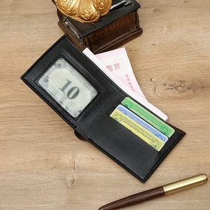 Macro detail of black litchi grain leather wallet with card slots and money compartment