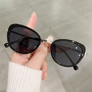 Chic retro cat eye sunglasses with oversized black frames and dark grey lenses for women