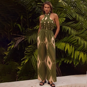 Detail of dark green halter neck jumpsuit with beige diamond pattern in tropical resort style