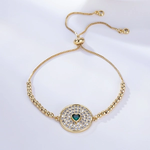 Adjustable gold bracelet with green heart stone and zircon pave on light silk