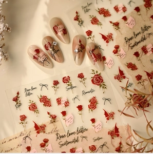 Macro view of French rose nail stickers with romantic floral designs and elegant scripts