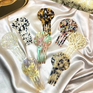 Elegant 4-prong acetate hair forks in various leopard and floral patterns on gold silk