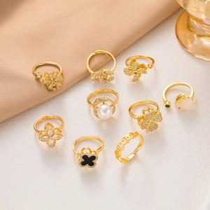 Adjustable 14k gold plated rotating rings for women featuring clover and pearl designs