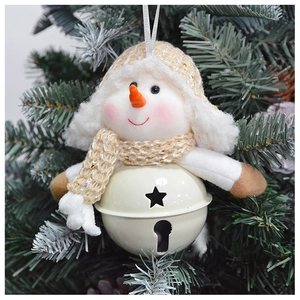 Macro detail of snowman plush bell ornament hanging on green Christmas tree branches