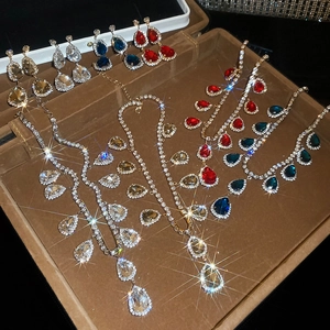 Macro detail of tear-drop crystal jewelry set with sparkling rhinestones in a velvet box