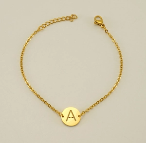 Detailed close-up of a golden titanium steel hollow letter A charm bracelet with extension chain