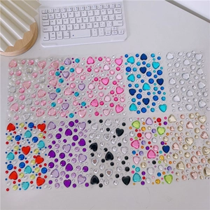 Macro shot of 3D colorful heart and round crystal diamond stickers for DIY crafts