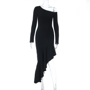 Detail of black one-shoulder dress showing asymmetric ruffled hem and slim-fit fabric