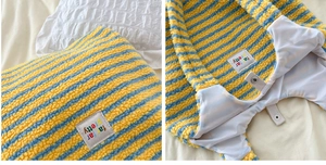 Detail view of the yellow and blue striped plush tote bag with magnetic snap closure